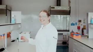An Access to Health & Life Sciences SWAP student at Fife College smiles at the camera while in a science lab