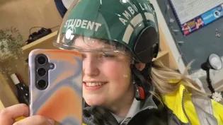 Nicole, dressed in her student paramedic uniform, takes a mirror selfie