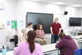Two former SWAP Access to Medical Studies students sit at the front of a classroom and answer current SWAP students' questions